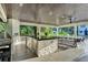 Expansive outdoor kitchen featuring stone counters, stainless appliances, and dining area with ceiling fan at 900 W Plant St, Winter Garden, FL 34787