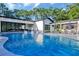 Beautiful backyard pool with lounge chairs and modern home exterior with outdoor seating areas at 900 W Plant St, Winter Garden, FL 34787