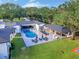 View of pool with outdoor seating, a covered patio and lots of trees at 900 W Plant St, Winter Garden, FL 34787