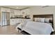 Modern studio with bedroom area and a kitchen with stainless steel appliances and white cabinets at 900 W Plant St, Winter Garden, FL 34787