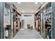 This walk-in closet boasts custom cabinets and drawers with glass fronts and a window for natural light at 900 W Plant St, Winter Garden, FL 34787