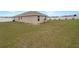 Spacious backyard featuring a lawn and partial fencing at 947 Cumberland Dr, Kissimmee, FL 34759