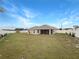 Expansive backyard with lush green lawn and a screened-in porch, ideal for outdoor enjoyment at 947 Cumberland Dr, Kissimmee, FL 34759
