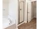Elegant bathroom showcasing a soaking tub, glass-enclosed shower, and modern fixtures at 947 Cumberland Dr, Kissimmee, FL 34759