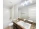 Bright bathroom featuring a tub with subway tile surround and vanity with granite countertop at 947 Cumberland Dr, Kissimmee, FL 34759