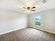 Serene bedroom with natural light from the window and a ceiling fan for added comfort at 947 Cumberland Dr, Kissimmee, FL 34759