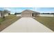 Charming single-story home featuring a spacious driveway and attached two-car garage at 947 Cumberland Dr, Kissimmee, FL 34759