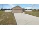 Attractive one-story home featuring a long driveway and an attached two-car garage at 947 Cumberland Dr, Kissimmee, FL 34759