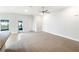 Bright living area with plush carpeting, fan, and natural light at 947 Cumberland Dr, Kissimmee, FL 34759