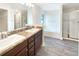 Main bathroom with soaking tub, dual sinks, and wood-look floors at 947 Cumberland Dr, Kissimmee, FL 34759