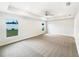 Spacious main bedroom with tray ceiling, carpeted floors, and bright windows at 947 Cumberland Dr, Kissimmee, FL 34759