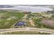 Picturesque aerial shot of a lakeside neighborhood featuring mature trees, a serene pond, and a quiet street at 10433 Trout Rd, Orlando, FL 32836