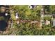 Aerial view of a lakefront property with mature trees, a house and water access with a dock at 10433 Trout Rd, Orlando, FL 32836