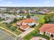 Stunning home with red tile roof, lush landscaping, and picturesque pond view at 10616 Emerald Chase Dr, Orlando, FL 32836