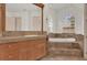Bright bathroom featuring a soaking tub, large vanity with a mirror, and tile flooring at 10616 Emerald Chase Dr, Orlando, FL 32836