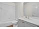 Well-lit bathroom featuring a tub and shower combination with a white sink and vanity at 10616 Emerald Chase Dr, Orlando, FL 32836