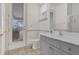 Bathroom featuring a single vanity, toilet, walk-out to screened in patio, and a large mirror at 10616 Emerald Chase Dr, Orlando, FL 32836