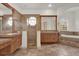 En-suite bathroom features tiled shower, bathtub, double vanity, and decorative windows at 10616 Emerald Chase Dr, Orlando, FL 32836