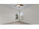 Neutral bedroom with carpet floors and two windows allowing natural light to illuminate the space at 10616 Emerald Chase Dr, Orlando, FL 32836