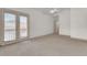 Bright bedroom with light-colored carpet and patio doors that flood the room with natural light at 10616 Emerald Chase Dr, Orlando, FL 32836