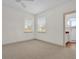 Carpeted bedroom with two windows that bring in natural light, plus en suite bathroom at 10616 Emerald Chase Dr, Orlando, FL 32836