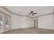 Neutral bedroom with crown molding, ceiling fan, and access to ensuite bathroom at 10616 Emerald Chase Dr, Orlando, FL 32836