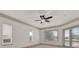 Bedroom with a ceiling fan, multiple windows, and a door to the backyard pool at 10616 Emerald Chase Dr, Orlando, FL 32836