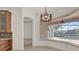 Breakfast nook with tiled floors, pool view, and modern light fixture at 10616 Emerald Chase Dr, Orlando, FL 32836