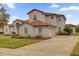 Elegant home with a tile roof, lush landscaping, a circular window and three car driveway at 10616 Emerald Chase Dr, Orlando, FL 32836