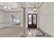 Elegant foyer featuring tile floors, a chandelier, arched doorways, and a front door with glass panels at 10616 Emerald Chase Dr, Orlando, FL 32836