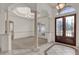 Grand foyer featuring tile floors with decorative inserts, a chandelier, and decorative columns at 10616 Emerald Chase Dr, Orlando, FL 32836