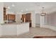 Eat-in kitchen with tile flooring, bar seating, wooden cabinetry, and modern light fixture at 10616 Emerald Chase Dr, Orlando, FL 32836