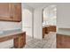 Kitchen area with arched doorways, tiled floors, and light-colored walls at 10616 Emerald Chase Dr, Orlando, FL 32836