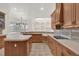 Bright eat-in kitchen with tile counters, wooden cabinets, and modern appliances at 10616 Emerald Chase Dr, Orlando, FL 32836