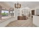 Open living space with hardwood floors, fireplace, pillars, and large windows overlooking the backyard at 10616 Emerald Chase Dr, Orlando, FL 32836