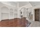 Spacious living room with fireplace, hardwood floors, columns, and staircase at 10616 Emerald Chase Dr, Orlando, FL 32836
