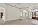 Open-concept living room featuring tiled floors, archways, and seamless transitions to other living spaces at 10616 Emerald Chase Dr, Orlando, FL 32836