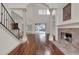 Open Living space with hardwood floors, fireplace, columns, and pool view at 10616 Emerald Chase Dr, Orlando, FL 32836