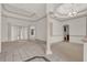Spacious living room showcasing tile floors, elegant archways, neutral walls, and abundant natural light at 10616 Emerald Chase Dr, Orlando, FL 32836