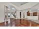 Staircase and bright living space with hardwood floors, tile, columns, and natural light at 10616 Emerald Chase Dr, Orlando, FL 32836