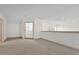 Bright loft area features neutral carpet, white walls, and natural light filtering in from the window at 10616 Emerald Chase Dr, Orlando, FL 32836