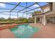 Backyard pool and jacuzzi area, enclosed with a screened cage, and featuring a view of a manicured lawn at 10616 Emerald Chase Dr, Orlando, FL 32836