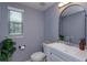 Well-lit bathroom with modern finishes, stylish mirror, and ample natural light at 1077 Fountain Coin Loop, Orlando, FL 32828