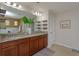Bathroom with dual sinks, granite counters, and decorative shelving above cabinets at 1077 Fountain Coin Loop, Orlando, FL 32828