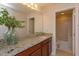 Bathroom featuring granite countertop, under-sink cabinet, an open doorway to the shower and toilet at 1077 Fountain Coin Loop, Orlando, FL 32828