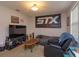 A versatile bonus room with casual seating, entertainment center, and a large banner on the wall at 1077 Fountain Coin Loop, Orlando, FL 32828