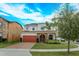 Charming two-story home featuring stone accents, a brick driveway, and a well-manicured lawn at 1077 Fountain Coin Loop, Orlando, FL 32828