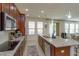 Well-equipped kitchen with stainless steel appliances, a cooktop, and island bar seating at 1077 Fountain Coin Loop, Orlando, FL 32828
