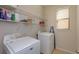 Well-lit laundry room with modern washer and dryer, and convenient overhead storage at 1077 Fountain Coin Loop, Orlando, FL 32828