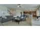 Open-concept living room with staircase, tile flooring, and an open view into the kitchen and dining area at 1077 Fountain Coin Loop, Orlando, FL 32828